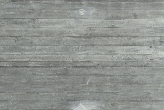Gray exposed concrete wall with molded wood grain &ndash; characteristic structure visible through board formwork.