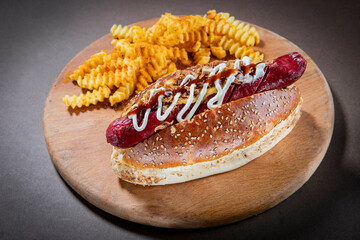 Gourmet Hot Dog with Crinkle-Cut Fries, Topped with Mayo, BBQ Sauce, and Crispy Onions