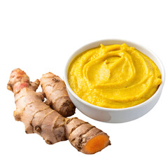 Turmeric and ginger paste in a bowl, surrounded by ingredients