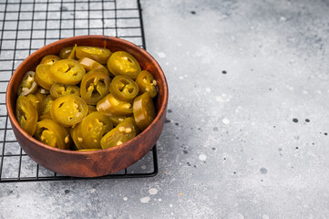 Pickled Jalapeno, Marinated Green Mexican pepper Slices. grey background. top view