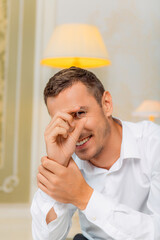 Smiling man looking through engagement ring