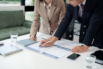 business team meeting with consultant and project planning charts.