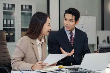 business team meeting with consultant and project planning charts.