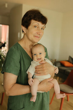 Grandmother bonding with baby in a loving family home setting