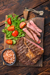 BBQ Grilled Rib eye steak on wooden board, roast  beef meat. wooden background. top view
