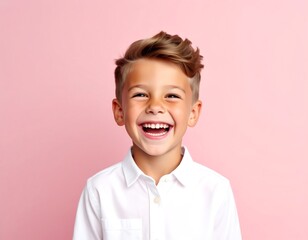 Joyful young boy with short brown hair, laughing broadly while wearing a white collared shirt against a solid pink background