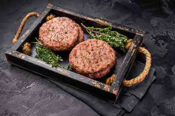 Grilled hamburger mince meat patties with herbs. black background. top view