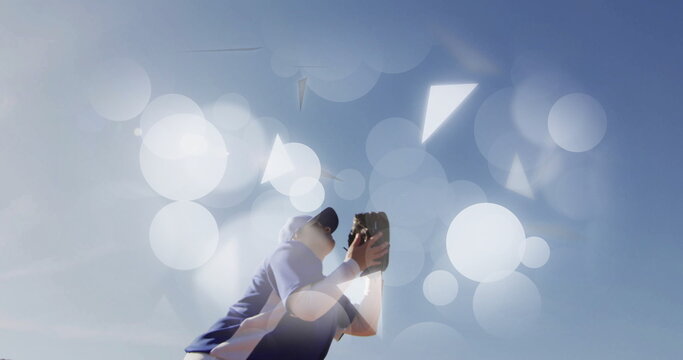 Reaching teen girl in blue cap jersey stretching glove on field with bokeh copy space - Powered by Adobe