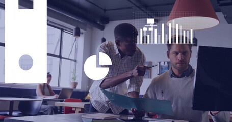 Collaborating professionals leaning, pointing pen at computer monitor in modern office, with plants