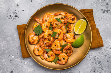 BBQ dinner with roast Shrimps Prawns in a plate. Gray background. Top view