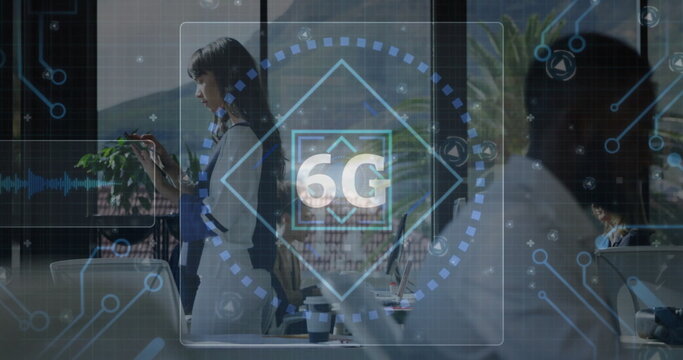 Projecting transparent 6G holographic interface in open-plan office, featuring smartphone, laptops