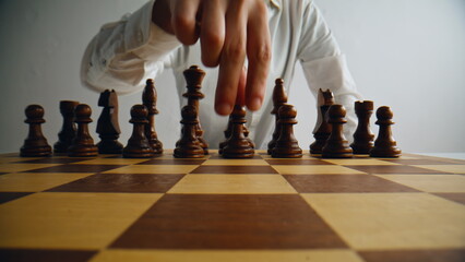 Unknown grandmaster playing chess at home. Man hand making move brainstorming