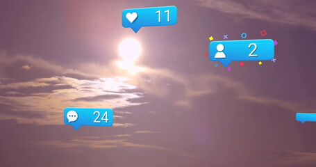 Glowing sun shining behind wispy clouds at sunset with floating heart11, comment24, user2 icons