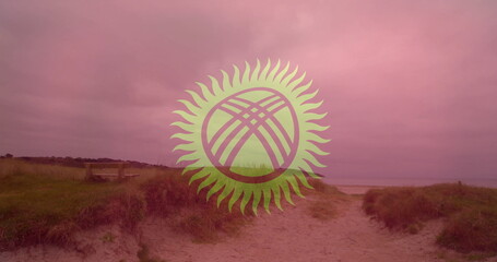 Sandy pathway winding through grassy dunes toward shore with wooden bench and stylized sun emblem
