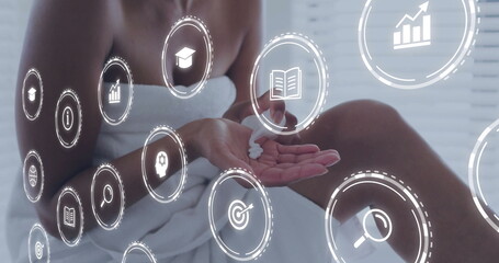 Applying body cream woman wrapped in white towel sitting on spa bench, with floating digital icons