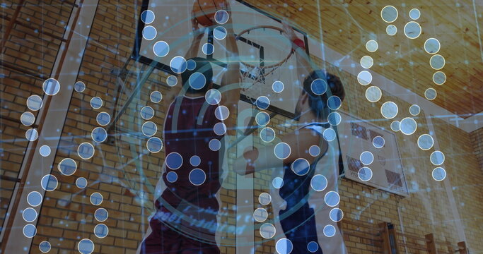 Leaping athletes performing dunk and block in gym, with basketball and hoop network overlay - Powered by Adobe