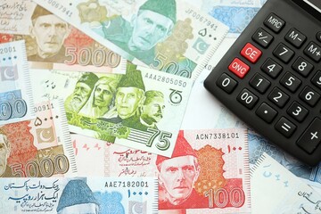 Pakistan rupees banknotes and calculator. The current Pakistan money bills with calculator