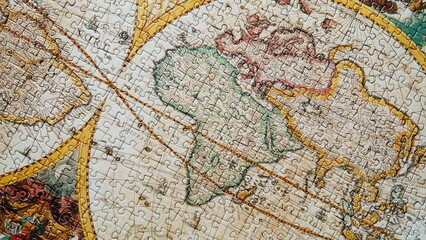 Top view assembled map puzzle. Jigsaw antique geographical landscape closeup