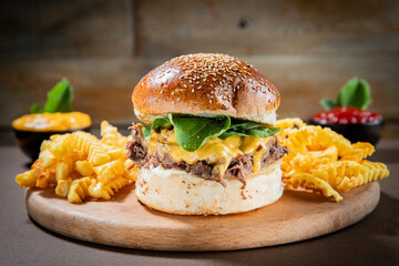 Gourmet Shredded Beef Burger with Cheddar Cheese, Greens, and Crinkle-Cut Fries