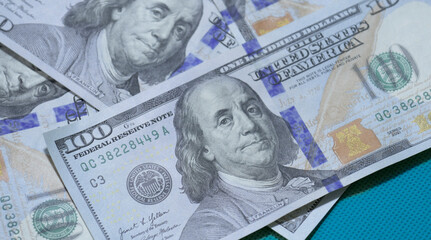 Currency bills featuring Benjamin Franklin in close-up view showcasing detailed design elements and...