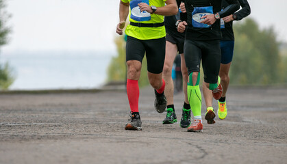 group athletes runners running in river embankment marathon race