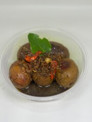 eggs in shrimp paste and soy sauce in a white bowl