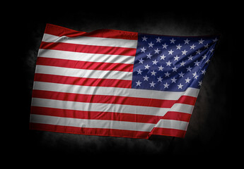 A dramatic image of the American flag waving against a dark cloudy background