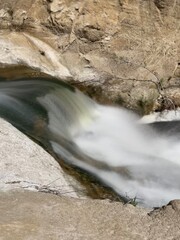 A Long-Exposed Waterfall through Rock