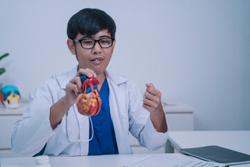 At the clinic, the cardiologist examined a human patient's medicals, discussing disease management...