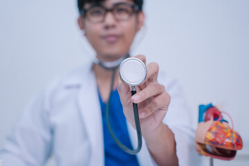 In the bustling hospital, the doctor used a stethoscope to listen to the patient's heartbeat during...
