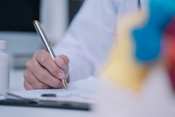 In the laboratory, the doctor, a dedicated lecturer in anatomy, was examining the human skull closely, taking detailed notes to enhance his students' education on cranial structure.