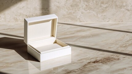 Minimalist white jewelry box mockup, plain and empty, displayed on a sophisticated marble surface.