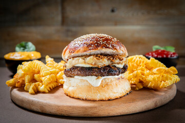 Beef Burger with Fried Onions and Crinkle Fries on Wooden Plate