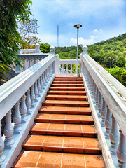 Stairway leading to a serene Buddhist temple in Vietnam surrounded by lush greenery