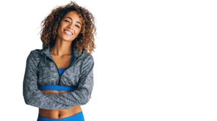 A happy woman in activewear smiles confidently, embodying fitness and positivity.