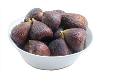 Fototapeta premium a bowl of figs on a white table