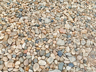 Natural stones scattered across a textured surface ideal for landscaping and decorative purposes