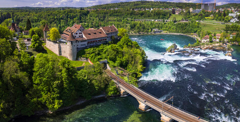 Switzerland tourism . Rheinfall (Rhine Falls) biggest waterfall in Europe in Schaffhausen , aerial drone view of Laufen castle and bridge . Swiss - German border.