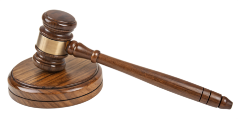 A wooden gavel and its sounding block. The gavel, made of a dark, richly grained wood, has a brass band around its head. The sounding block is a circular piece of matching wood.