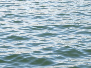 A close up shot of the surface of the water with small ripples and slight color variation