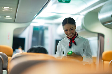Cabin crew member in uniform smiling softly, candidly captured in aircraft aisle, reflecting...