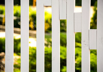 White wooden fence with greenery background for outdoor design