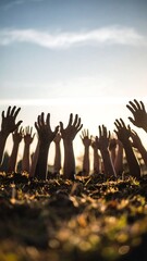 Many hands reach upward from a dark, earthy pit against a bright sky