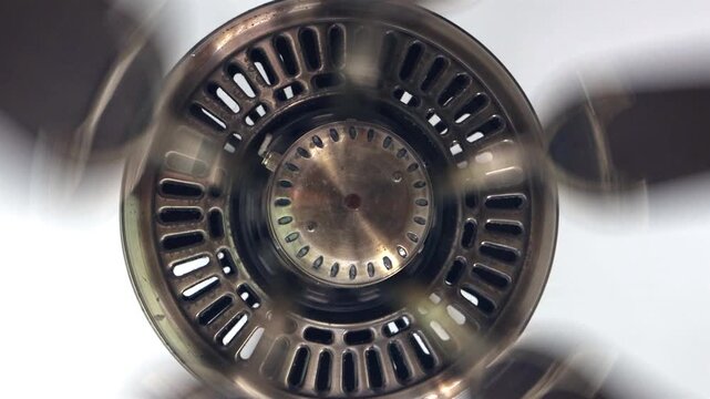 Close-Up view of a spinning brass ceiling fan in motion