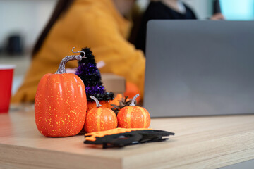 Halloween Decor. Festive orange pumpkins and decorations on a wooden table.