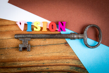 Vintage Key and Colorful Vision Letters on Desk
