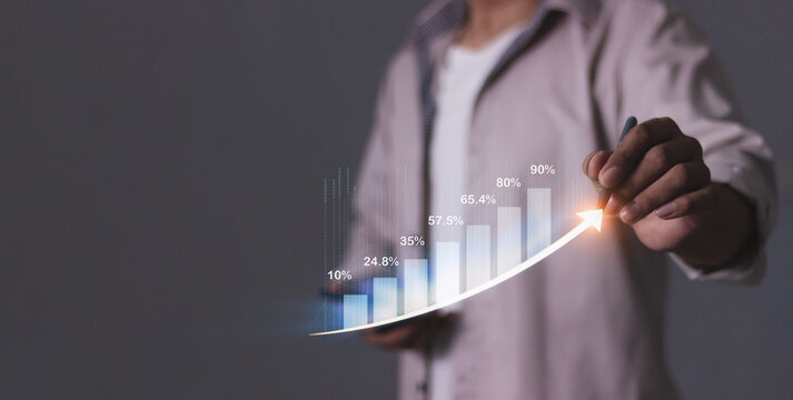 Young man with smartphone hand touching to visualize money growth The phone screen displays graphs and charts showing increasing investment and savings trends, along with an increased account balance - Powered by Adobe