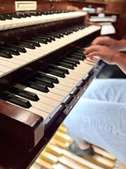 young woman playing organ, two manuals and pedal