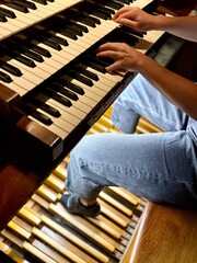 young woman playing organ, two manuals and pedal
