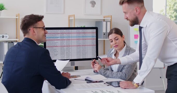 Business people at work in office. Company employees having discussion analyzing company accounting on meeting and discussing financial data on pc computer with charts. 4k video. Slow motion video. - Powered by Adobe
